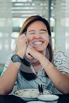 Woman eating food on dining table in restaurant