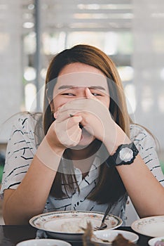 Woman eating food on dining table in restaurant