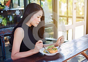 Woman eating food in a restaurant