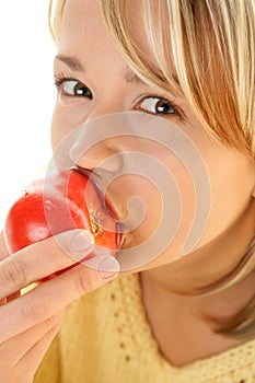 Woman eating fresh tomato