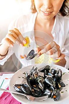 Woman Eating Freshly cooked Mussels