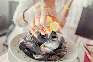 Woman Eating Freshly cooked Mussels