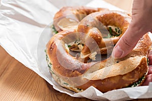 Woman eating German Brezel pretzel with chives and butter