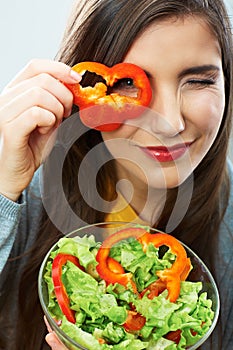 Woman eating green salad . Female model close up face studio is