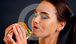 Woman eating hamburger. Girl wants to eat fast food.