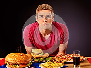 Woman eating hamburger. Student consume fast food.