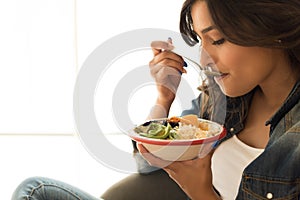 Woman eating a healthy bowl