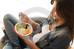 Woman eating a healthy bowl