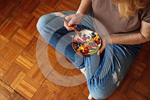 Woman eating healthy breakfast at home