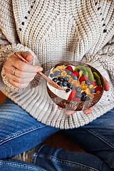 Woman eating healthy breakfast at home