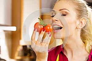 Woman eating healthy tomatoes