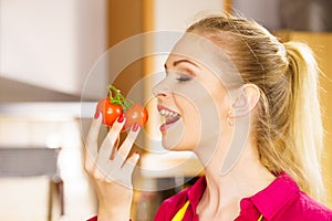 Woman eating healthy tomatoes