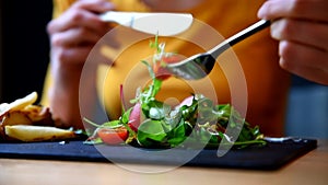 Woman eating her vegetable salad restaurant.