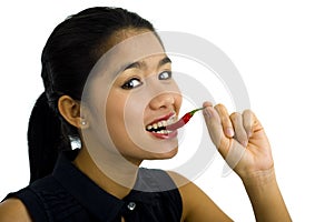 Woman eating a hot chili pepper