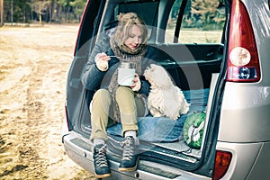 Woman is eating a hot dish from a thermos