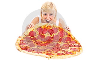 Woman eating huge pizza