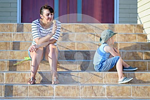 Woman Eating Ice Cream Near Sulking Boy