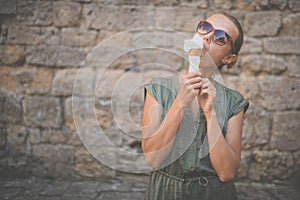 Woman eating ice cream outside photo