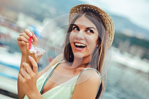 Woman eating ice cream on summer vacation in holiday beach resort