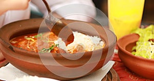 Woman is eating in indian restaurant