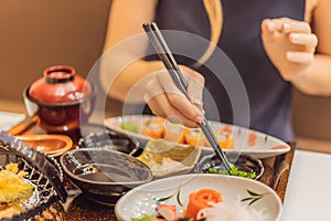 Woman eating japanese food in a japanese food restaurant