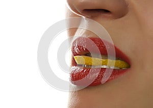 Woman eating juicy lemon, close-up lips on a white background.