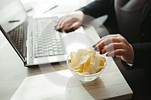 Woman eating junk food, snacking with chips