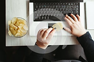 Woman eating junk food, snacking with chips