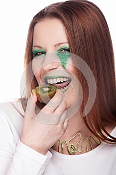 Woman eating kiwi