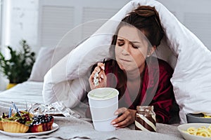 Woman eating a lot of desserts because of depression