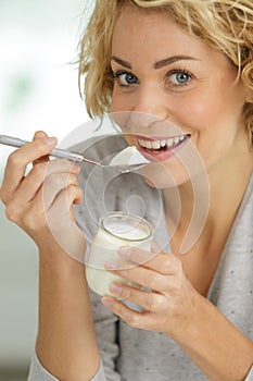 Woman eating natural yoghurt