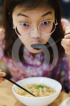 Woman eating noodle in restuarant