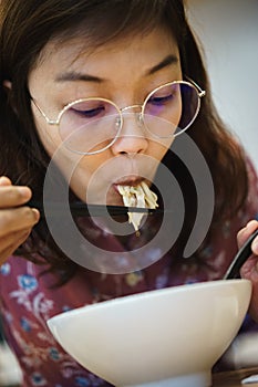 Woman eating noodle in restuarant