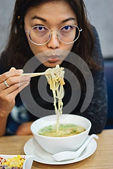 Woman eating noodle in restuarant