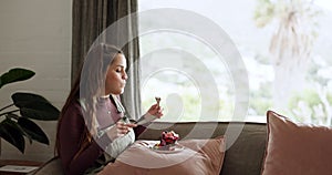 Woman, eating and pancakes for breakfast in morning, home and relax in living room with healthy food and window view