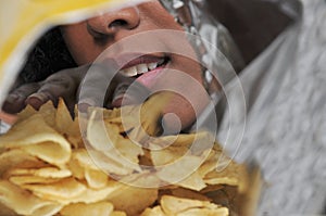 Woman eating potato chips