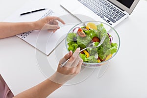 Woman eating salad during lunch