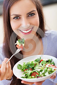 Woman eating salad