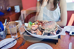 Woman eating seafood platter