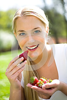 Woman eating strawberries
