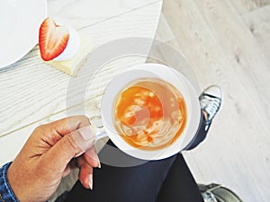 Woman eating strawberry cheesecake