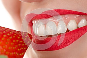 Woman eating strawberry, concept healthy teeth