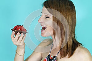 Woman eating a strawberry tartlet