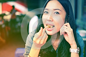 Woman eating Chinese steamed dumpling