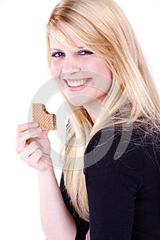 Woman eating a sweet chocolate snack