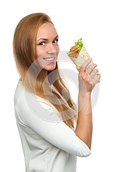 Woman eating tasty unhealthy burger twisted sandwich in hands