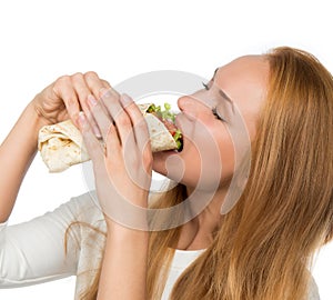 Woman eating tasty unhealthy twister sandwich in hands hungry