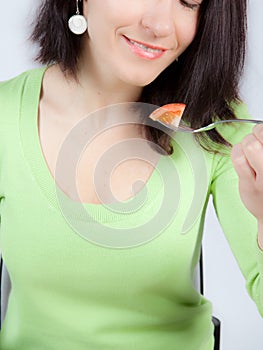 Woman eating tomato