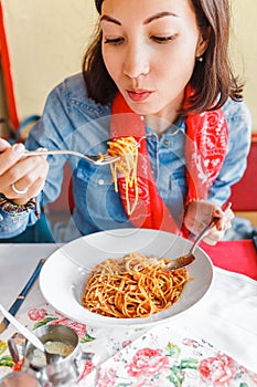 Woman eating traditional italian pasta in local restaurant