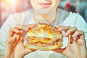 Woman eating traditional portuguese pork beef sandwich bifana . Traditional Portuguese food photo